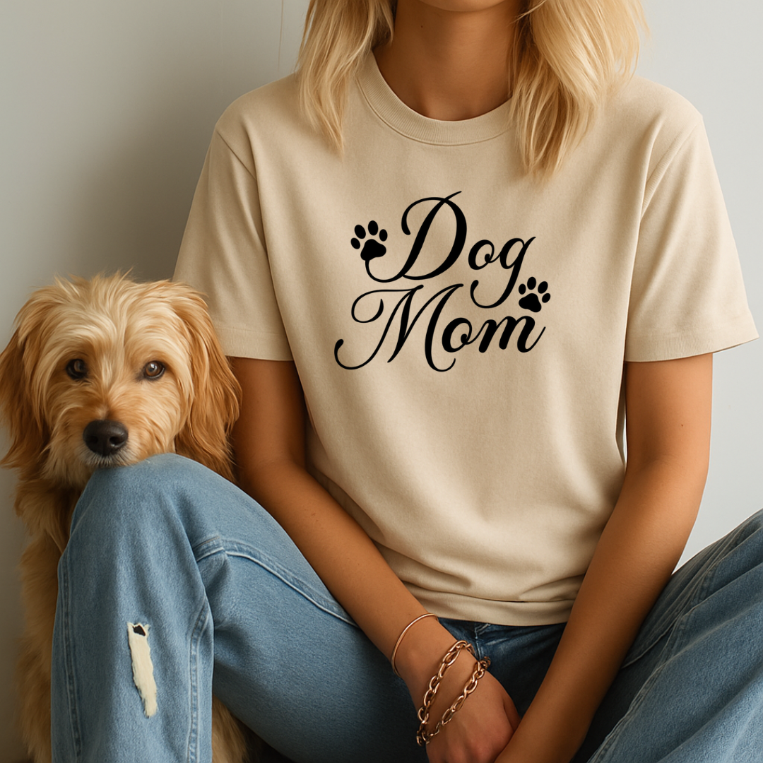 Person wearing a 'Dog Mom' t-shirt sitting next to a dog.