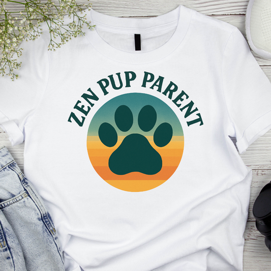 White t-shirt with 'Zen Pup Parent' design featuring a paw print on a wooden surface.