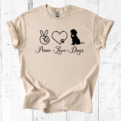Beige t-shirt with 'Peace Love Dogs' text and graphics on a white wooden background