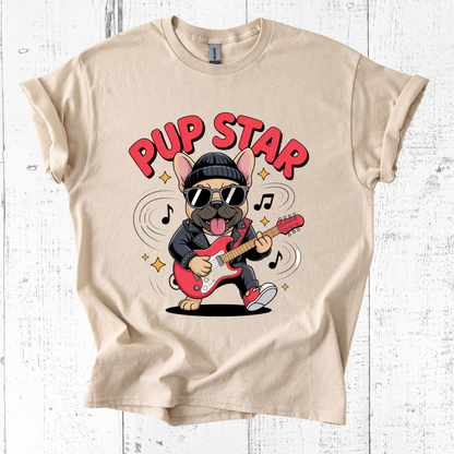 Beige t-shirt with a dog playing guitar graphic and 'Pup Star' text on a white wooden background