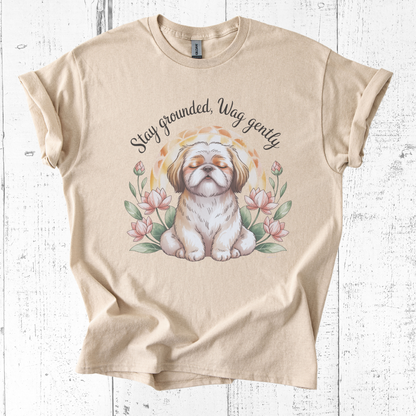 Beige t-shirt with a dog illustration and text on a wooden surface