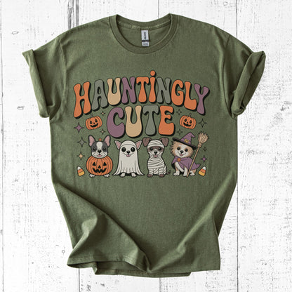 Green t-shirt with 'Hauntingly Cute' text and Halloween-themed graphics on a white wooden background