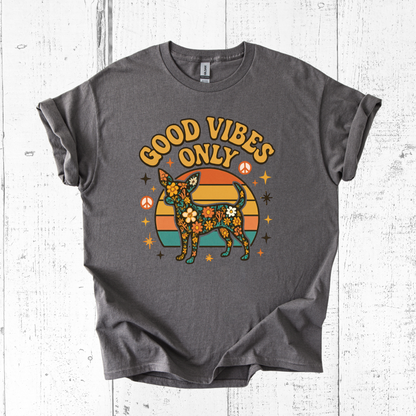 Gray t-shirt with 'Good Vibes Only' graphic on a wooden surface