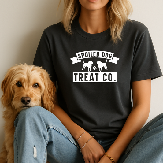 Person wearing a black t-shirt with 'Spoiled Dog Treat Co.' text and graphic, sitting next to a dog.