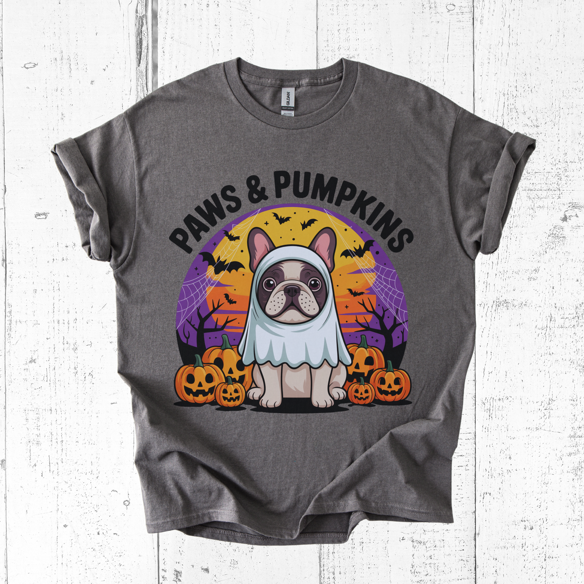 Gray t-shirt with a dog in a costume and 'Paws & Pumpkins' text on a white wooden background