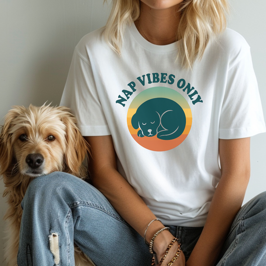 Person wearing a white t-shirt with a dog graphic and 'Nap Vibes Only' text, sitting next to a dog.