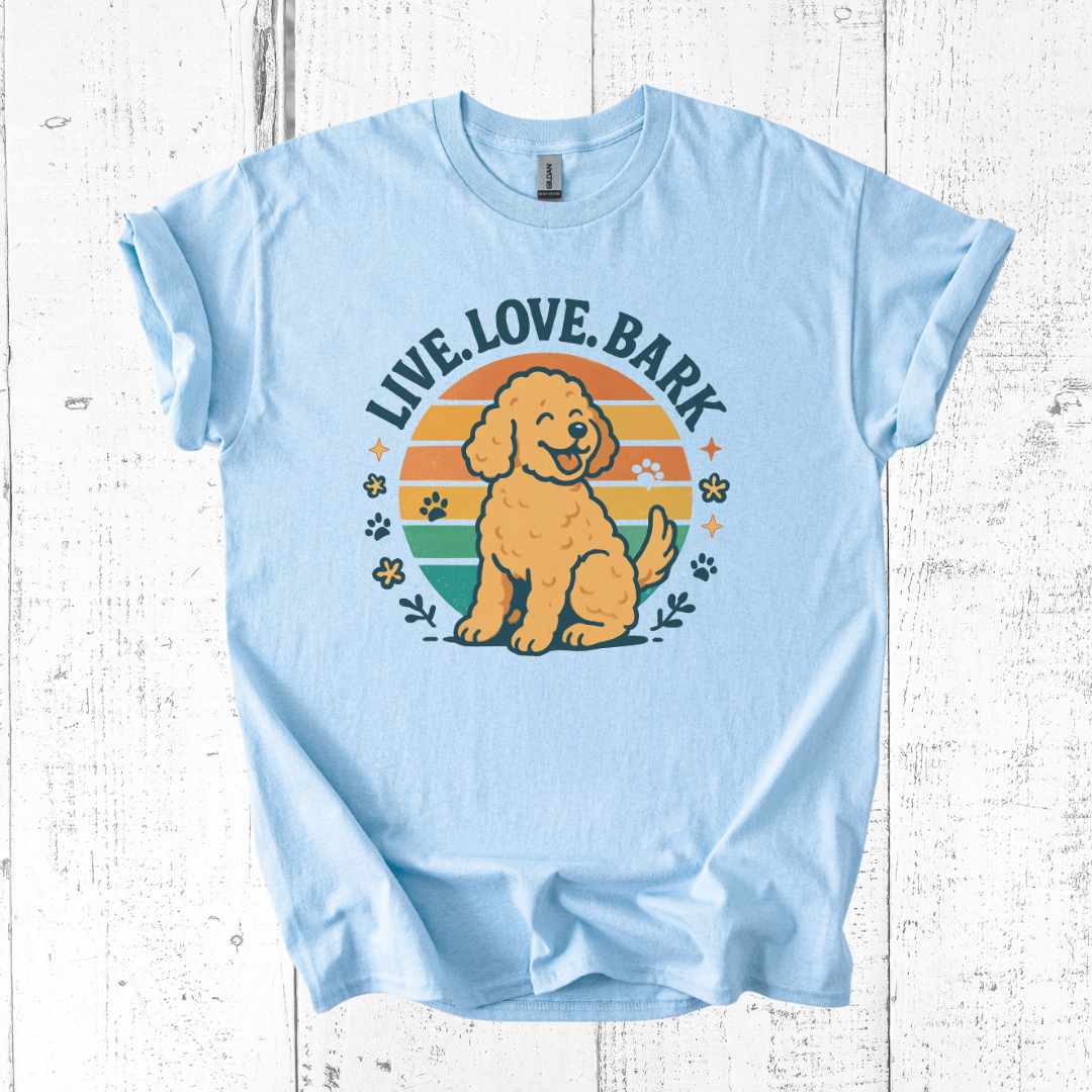 Light blue t-shirt with a dog graphic and 'Live Love Bark' text on a wooden surface