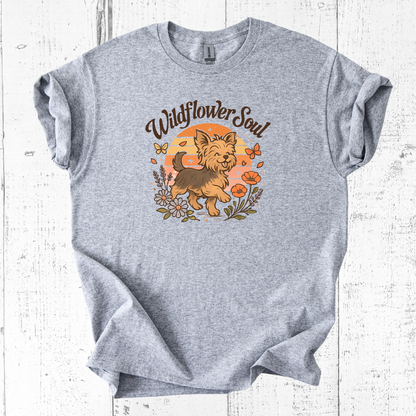 Gray t-shirt with a dog graphic and 'Wildflower Soul' text on a wooden surface