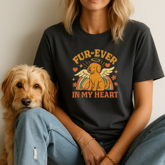 Person wearing a black t-shirt with a dog graphic and text, sitting next to a dog.
