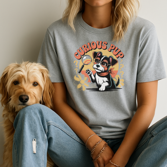 Person wearing a gray t-shirt with a dog graphic and 'Curious Pup' text, sitting next to a dog.