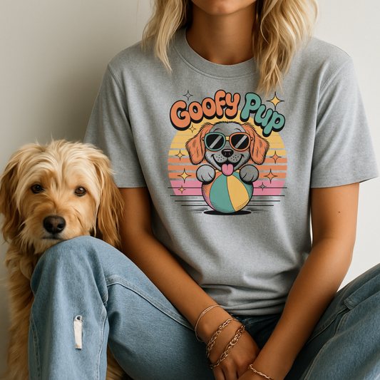 Person wearing a gray t-shirt with 'Goofy Pup' design sitting next to a dog.