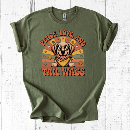 Green t-shirt with a dog graphic and text 'Peace, Love, and Tail Wags' on a white wooden background