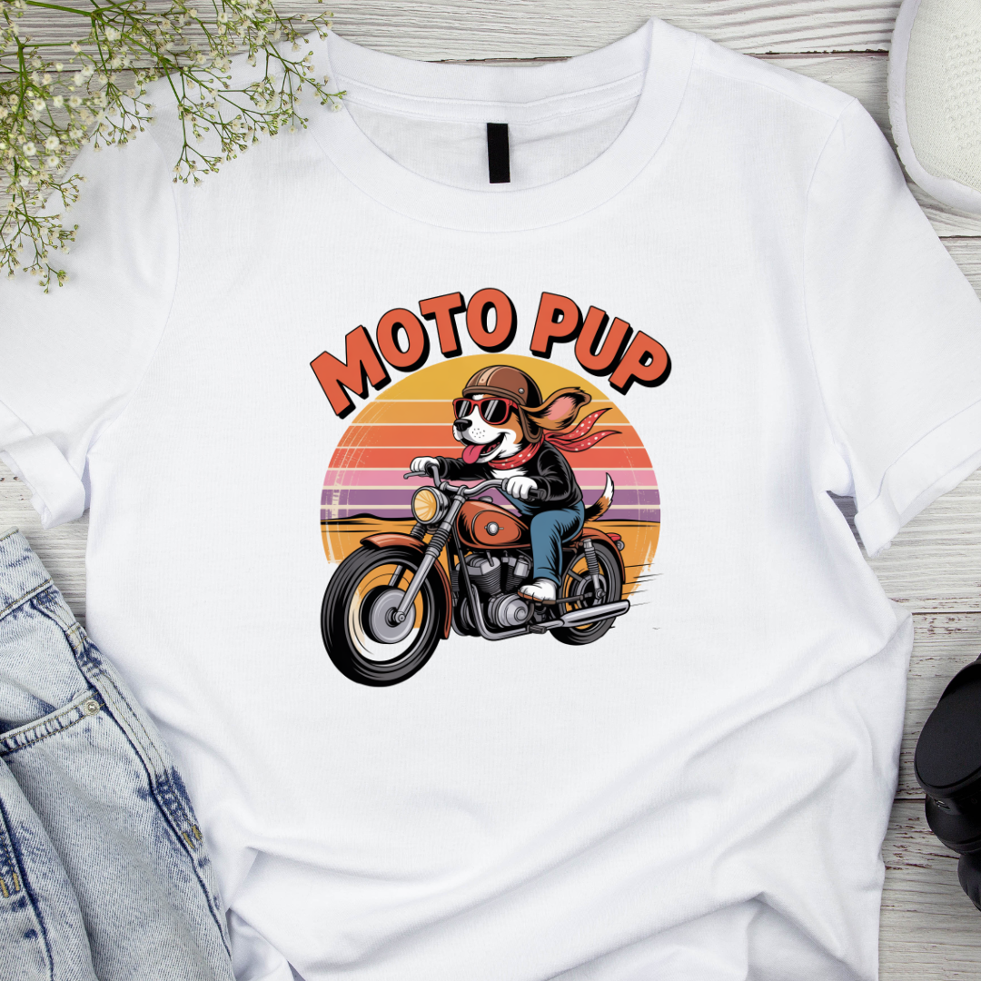 White t-shirt with 'Moto Pup' graphic design featuring a dog on a motorcycle, displayed on a wooden surface.