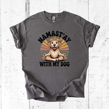 Gray t-shirt with a graphic of a dog meditating and 'Namast'ay with my dog' text on a white wooden background