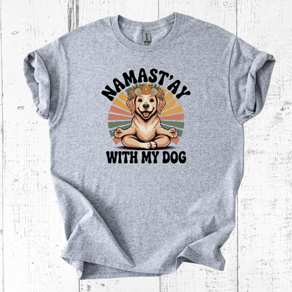 Gray t-shirt with a dog graphic and 'Namast'ay with my dog' text on a white wooden background