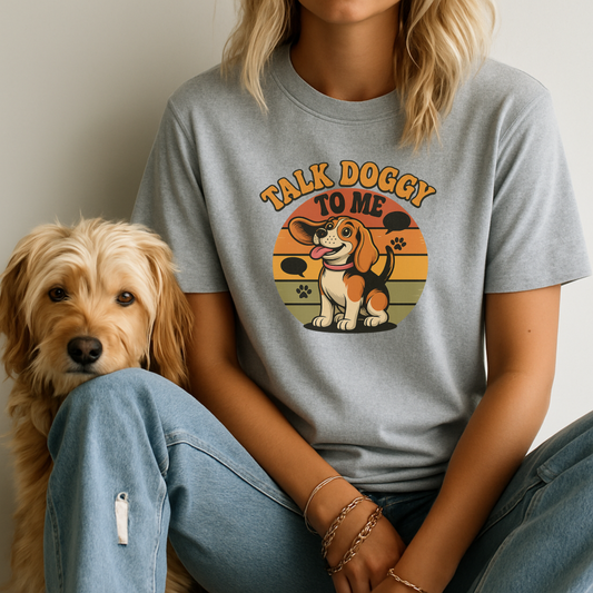 Person wearing a gray t-shirt with a dog graphic and text, sitting next to a dog.