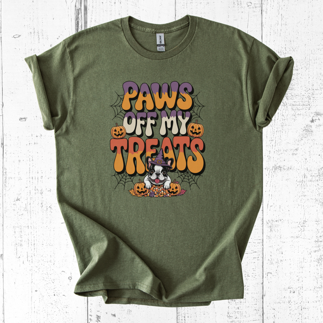 Green t-shirt with Halloween-themed graphic and text on a white wooden surface