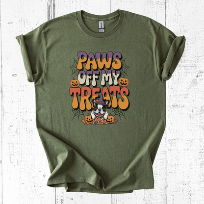 Green t-shirt with Halloween-themed graphic and text on a white wooden surface