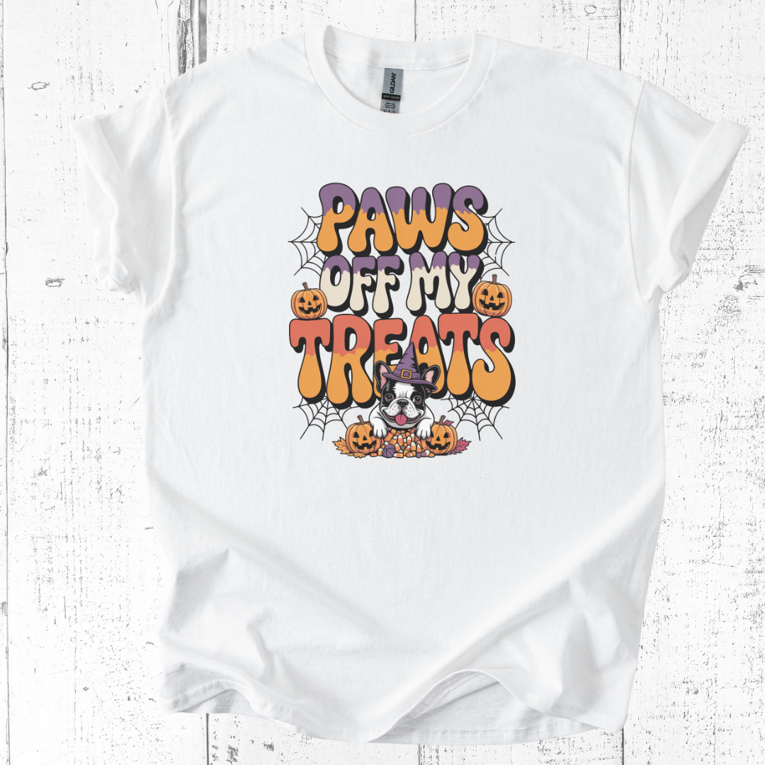 White t-shirt with Halloween-themed graphic and text on a wooden surface