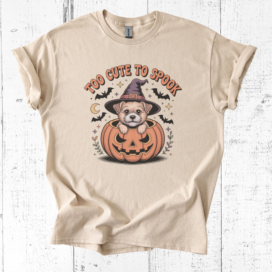 Beige t-shirt with a Halloween-themed graphic of a dog in a pumpkin.