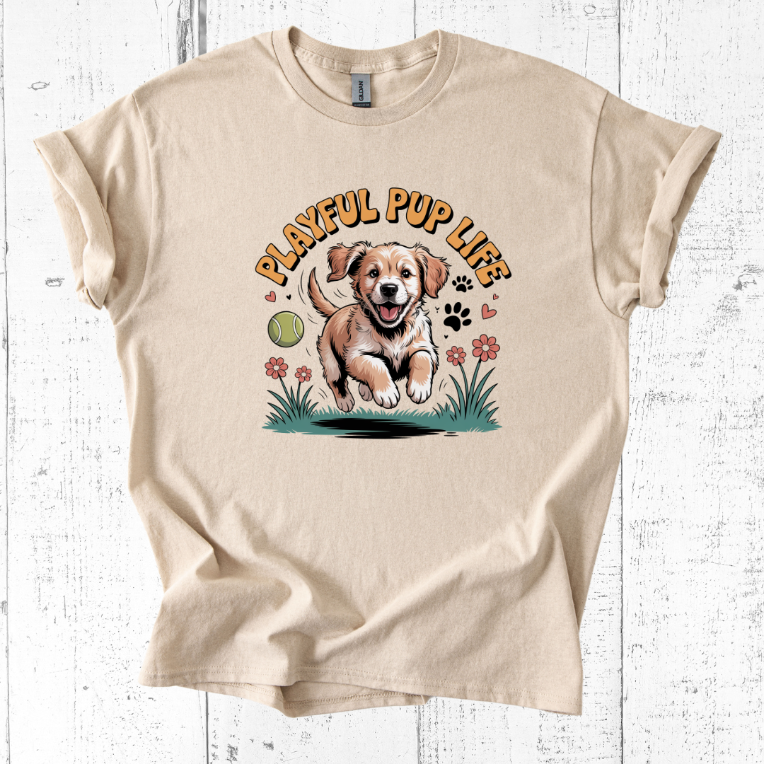 Beige t-shirt with a graphic of a puppy and 'Playful Pup Life' text on a white wooden background