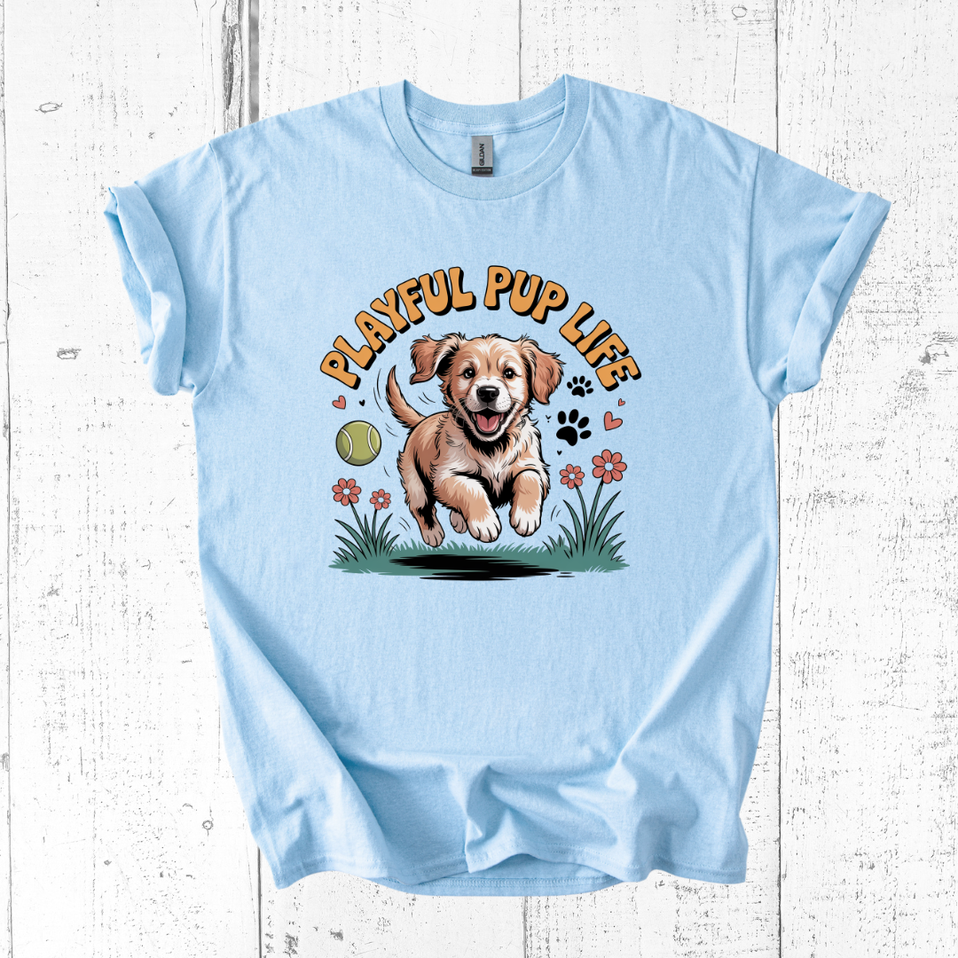 Light blue t-shirt with a graphic of a puppy and 'Playful Pup Life' text on a wooden surface.
