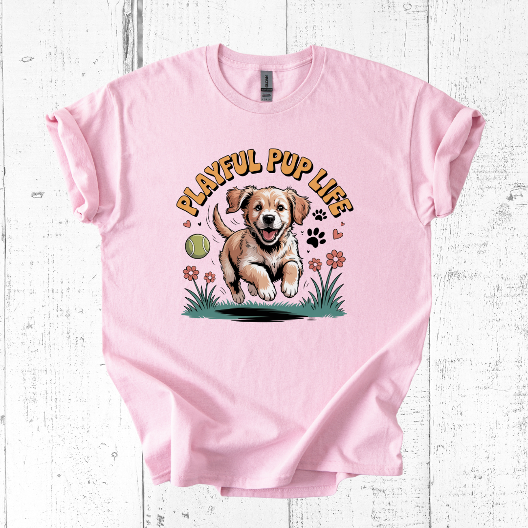 Pink t-shirt with a graphic of a puppy and 'Playful Pup Life' text on a white wooden background