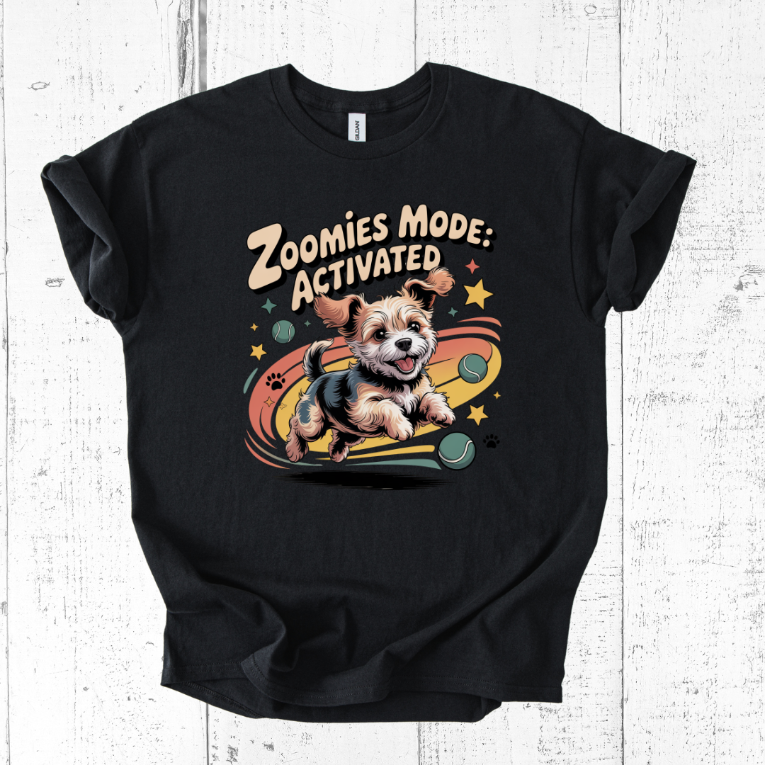Black t-shirt with a dog graphic and 'Zoomies Mode: Activated' text on a white wooden background