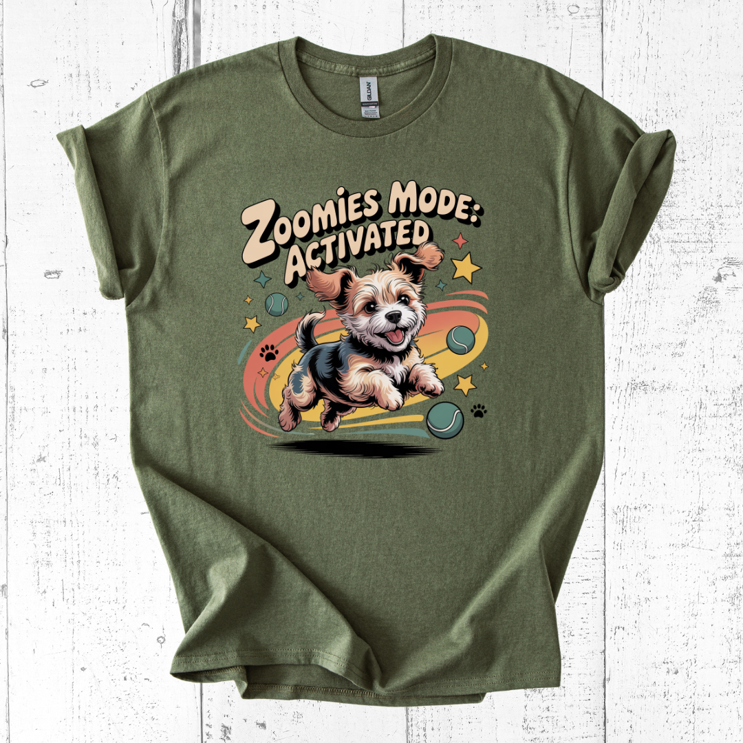 Green t-shirt with a dog graphic and 'Zoomies Mode: Activated' text on a white wooden background