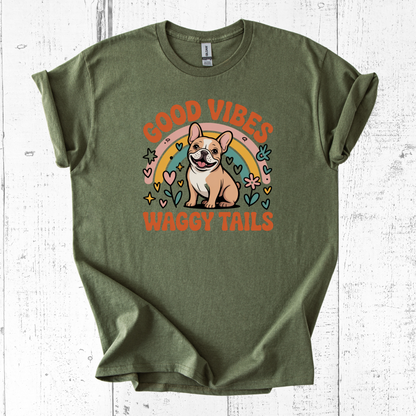 Green t-shirt with a dog graphic and 'Good Vibes Waggy Tails' text on a white wooden background