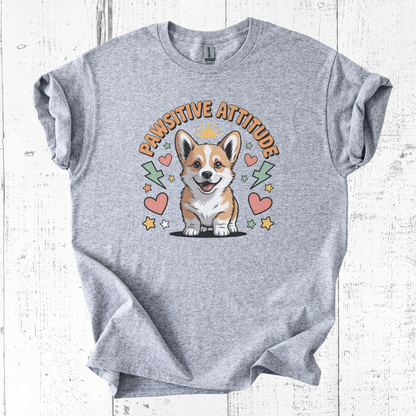 Gray t-shirt with a corgi graphic and 'Pawsitive Attitude' text on a white wooden background