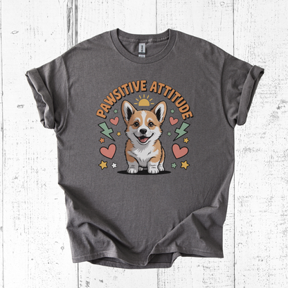 Gray t-shirt with a corgi graphic and 'Pawsitive Attitude' text on a wooden surface