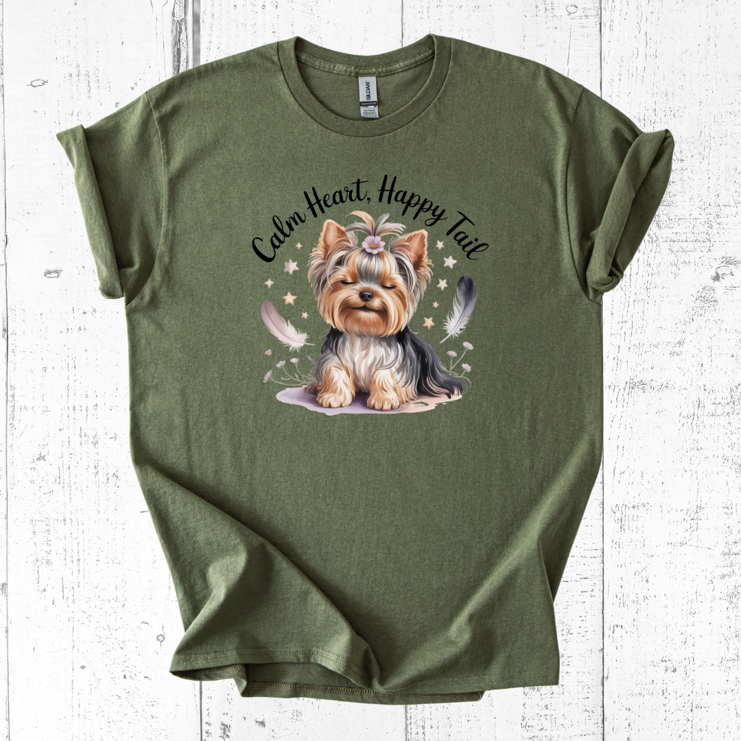 Green t-shirt with a dog illustration and text on a white wooden surface