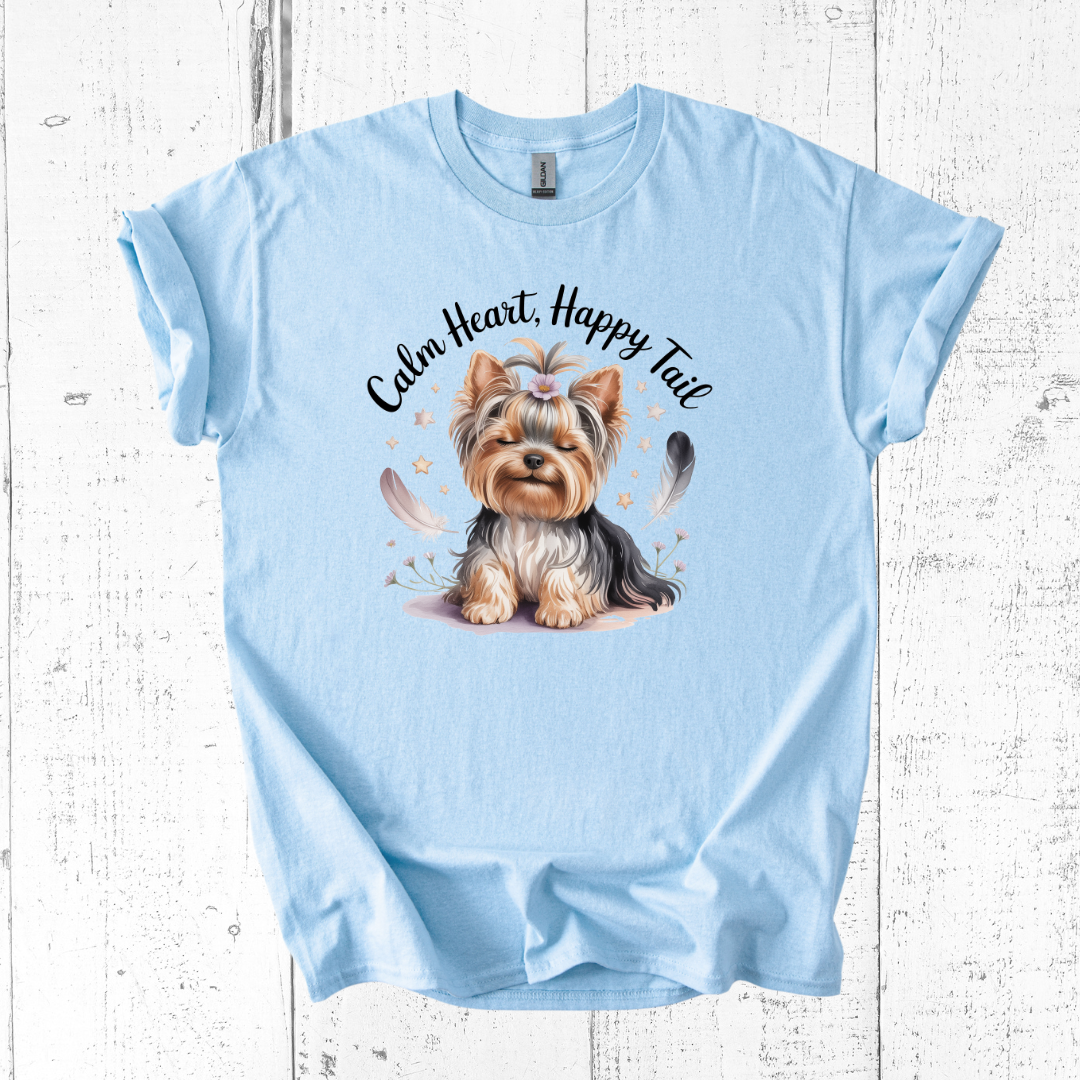 Light blue t-shirt with a dog graphic and text on a wooden surface