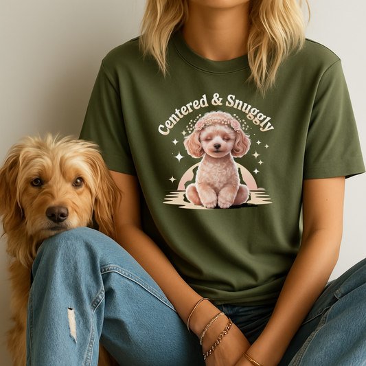 Person wearing a green t-shirt with a dog graphic and text, sitting next to a dog.