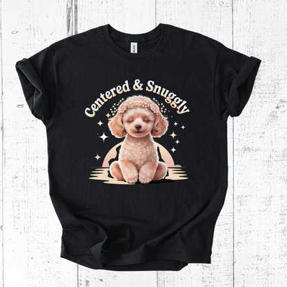 Black t-shirt with a graphic of a dog and text 'Centered & Snuggly' on a wooden surface