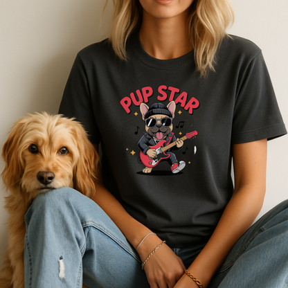 Person wearing a black t-shirt with 'Pup Star' design sitting next to a dog.