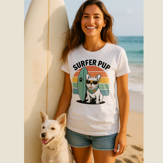 Woman wearing a 'Surfer Pup' t-shirt with a dog graphic on a beach