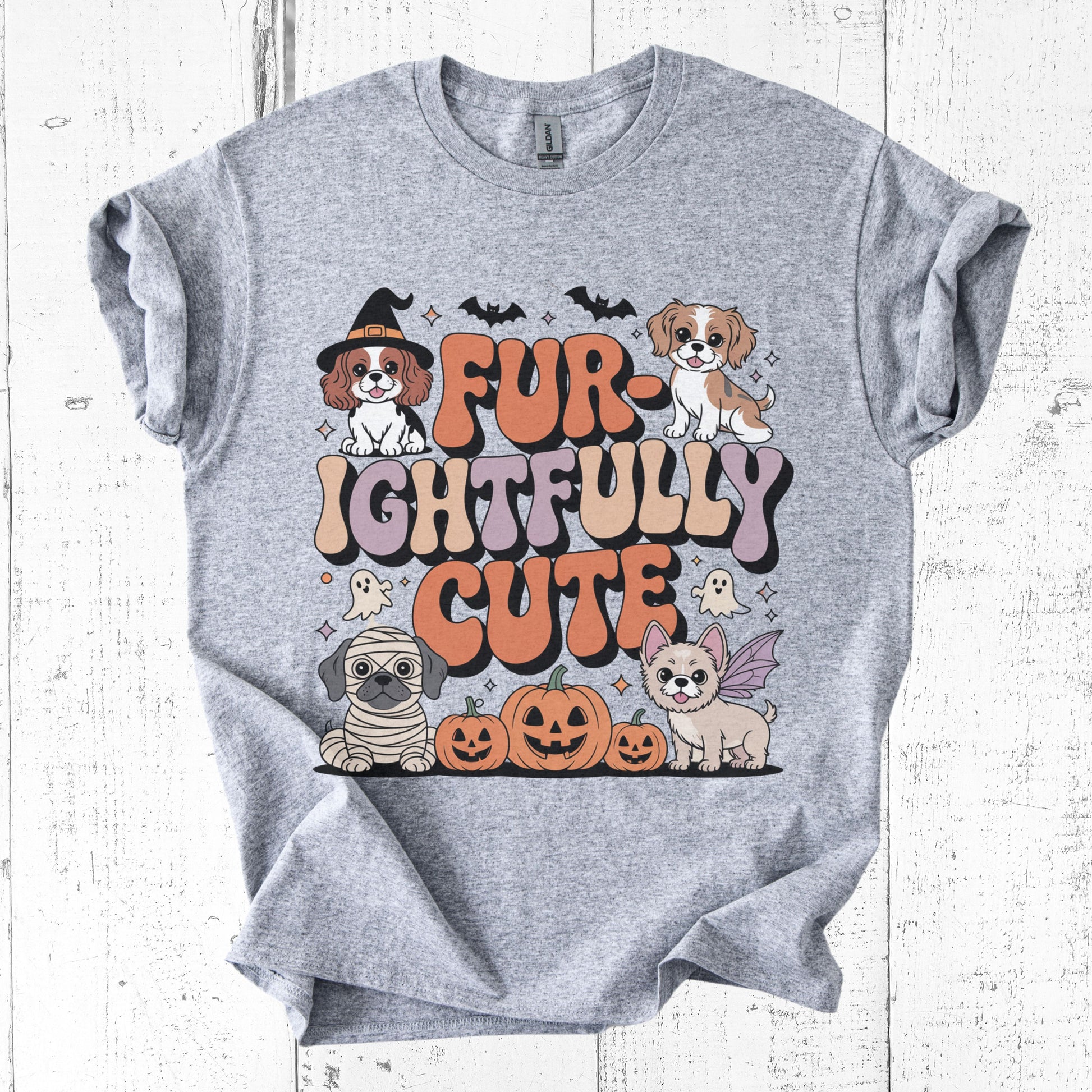 Gray t-shirt with Halloween-themed design featuring dogs and text on a white wooden background