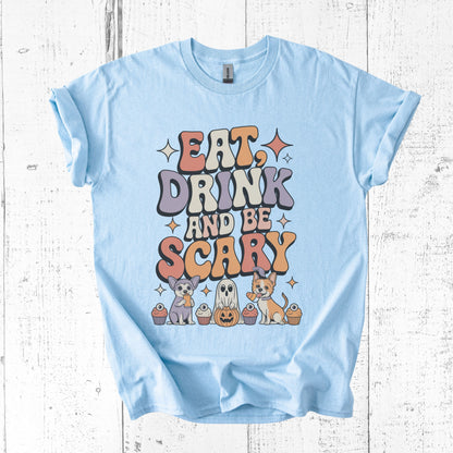 Light blue t-shirt with Halloween-themed design on a wooden surface
