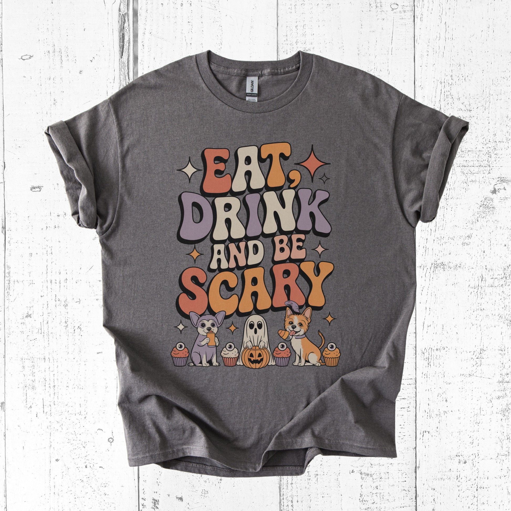 Gray t-shirt with Halloween-themed design on a white wooden surface