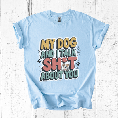 Light blue t-shirt with colorful text design on a wooden surface