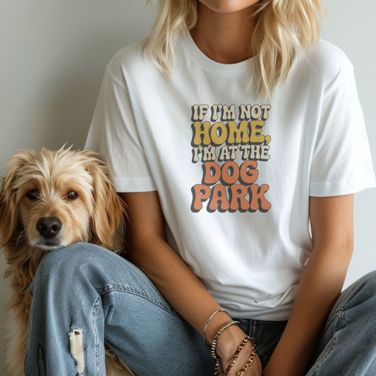 Person wearing a white t-shirt with a humorous dog-themed message, sitting next to a dog.