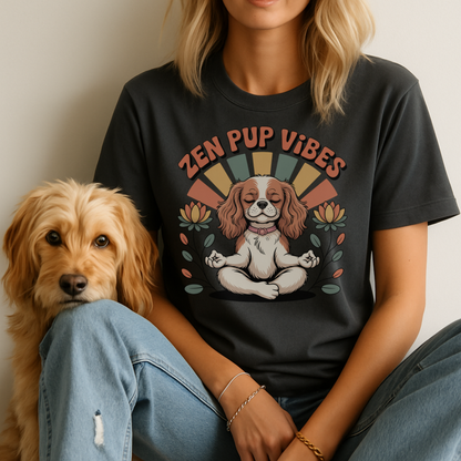 Person wearing a black t-shirt with 'Zen Pup Vibes' design sitting next to a dog.