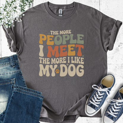 Gray t-shirt with colorful text design, paired with jeans and sneakers on a light wooden surface.