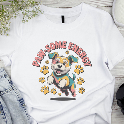 White t-shirt with a cartoon dog and 'Paw-some Energy' text on a wooden surface.