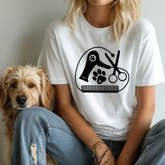 Person wearing a white t-shirt with a grooming logo sitting next to a dog.