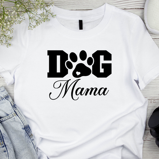 White t-shirt with 'Dog Mama' text and paw print design on a wooden surface.