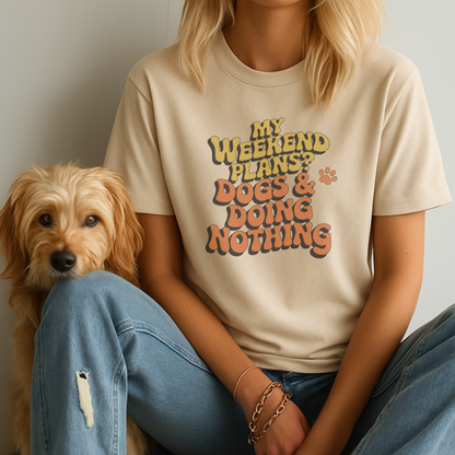 Person wearing a t-shirt with 'My weekend plans? Dogs & doing nothing' text sitting next to a dog.