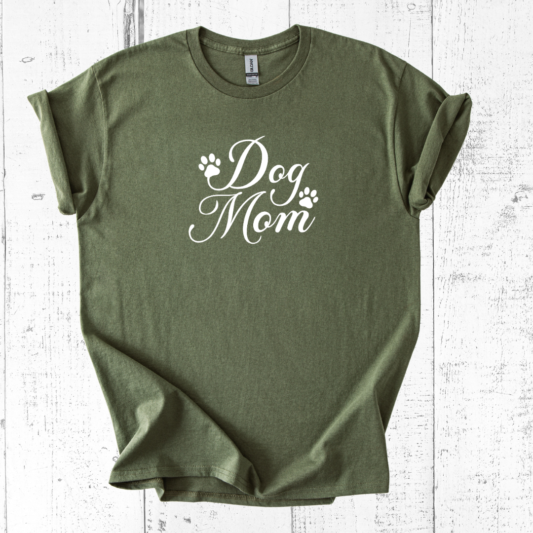 Green t-shirt with 'Dog Mom' text on a white wooden surface